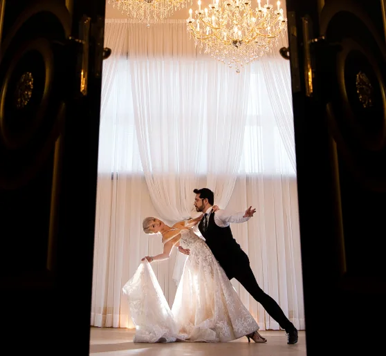 Bride and groom performing a dance under a chandelier at Carnegie Hall Ingersoll.